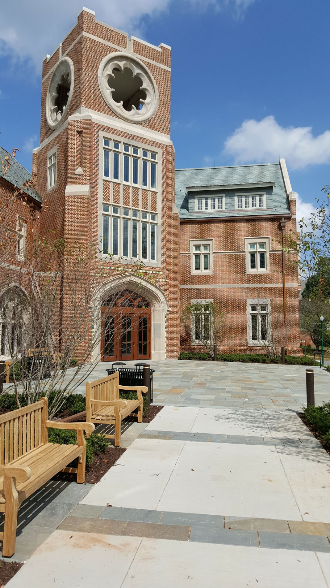 The entry walkway is concrete with bluestone bands, which leads to the bluestone entry plaza.